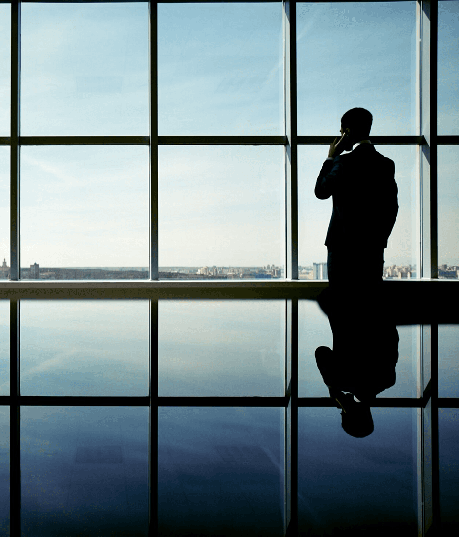 Professional looking out a window